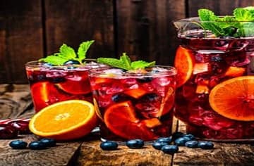 Homemade-Sangria-Ice-Cream-A-Taste-Of-Spain-featured-image-200x620w-jug-and-glasses-filled-with-sangria-and-fresh-fruit-scatter-around-frosted-fusions